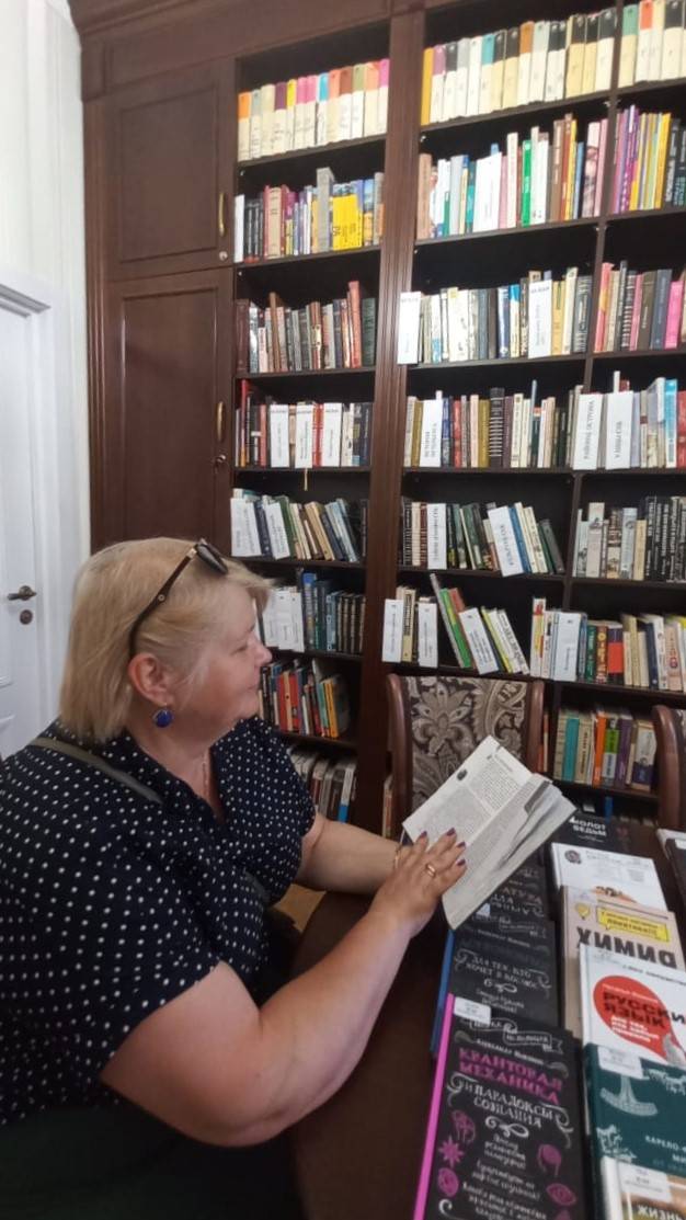 Ольга Германовна листает книги фонда